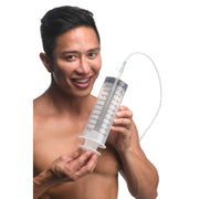 A man holds a large 550ml clear syringe with measurement markings and a silicone tube.