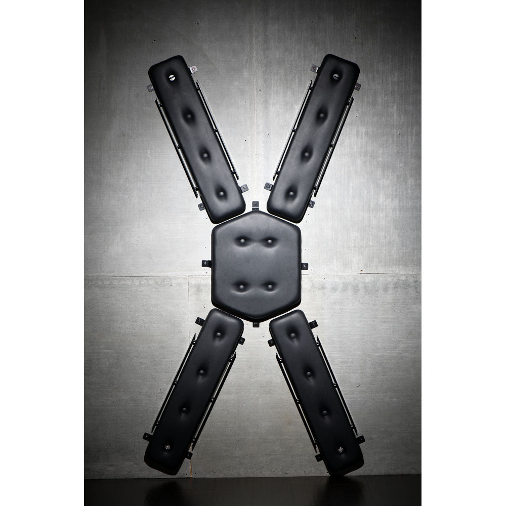 Wall-mounted St. Andrew's Cross with padded PVC leather.