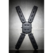 Wall-mounted St. Andrew's Cross with padded PVC leather.