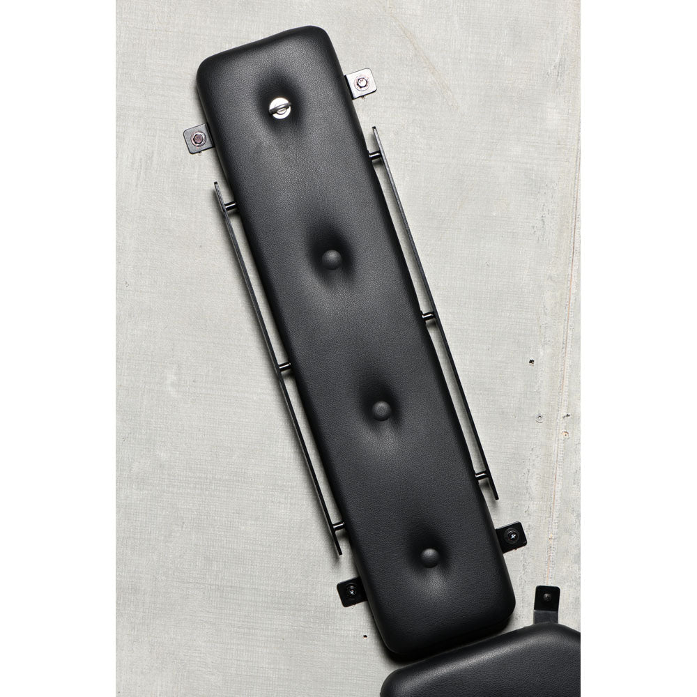 Wall-mounted St. Andrew's Cross with padded PVC leather.