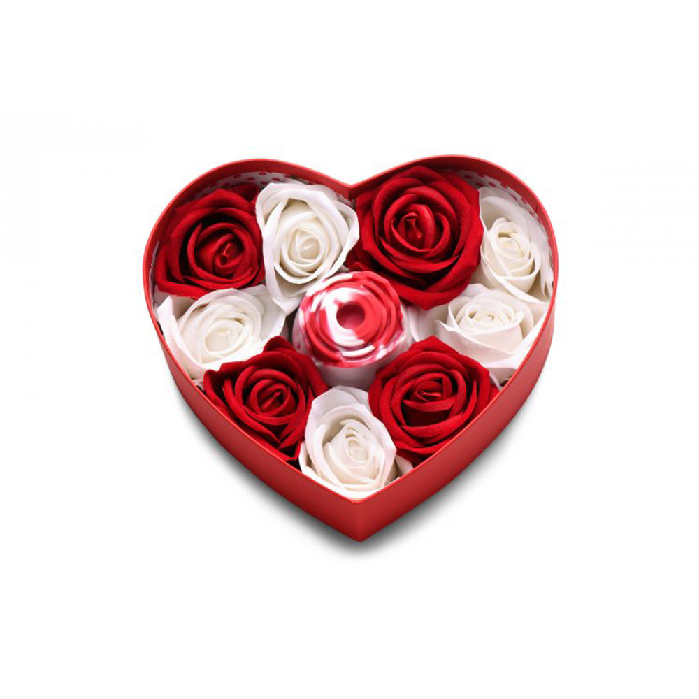 Heart-shaped box with red and white faux roses and a red and white swirl rose toy.