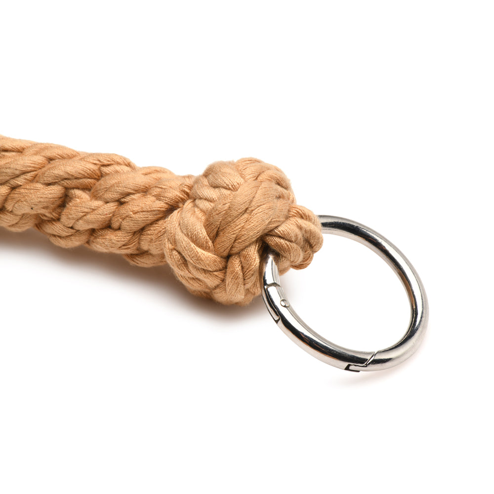 A tan rope flogger with a metal ring and clasp.