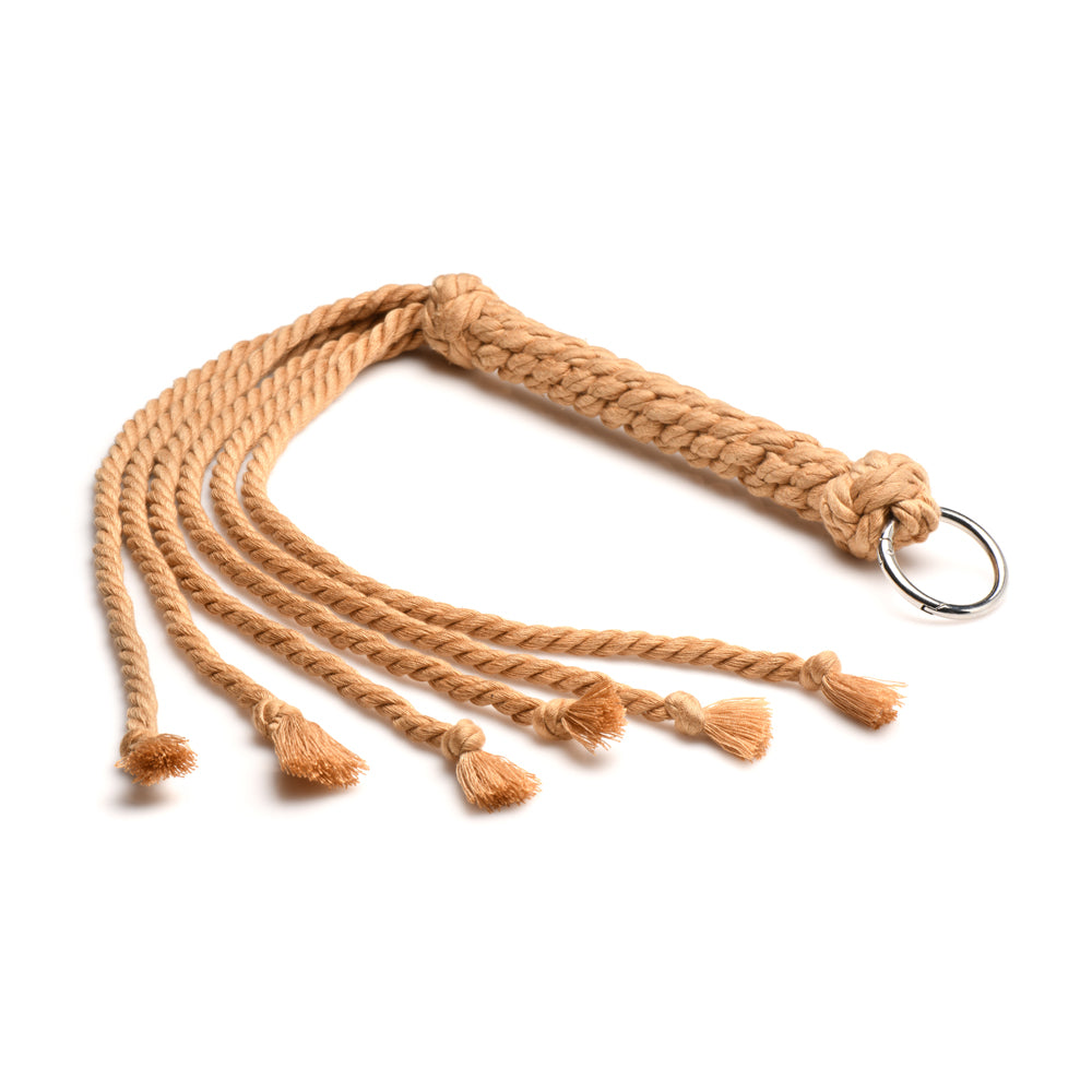 A tan rope flogger with six knotted tails and a metal ring.