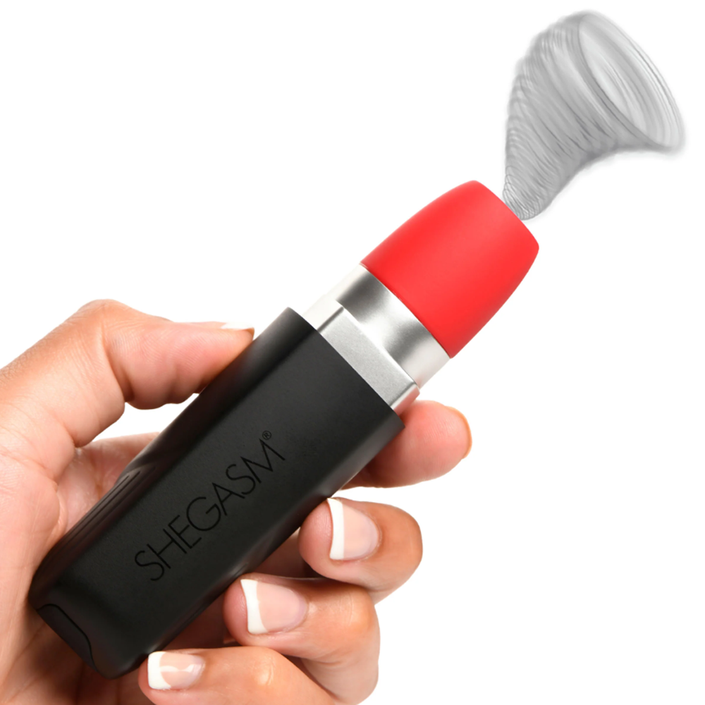 A hand holds a black and red lipstick-shaped vibrator with a swirling grey mist effect.