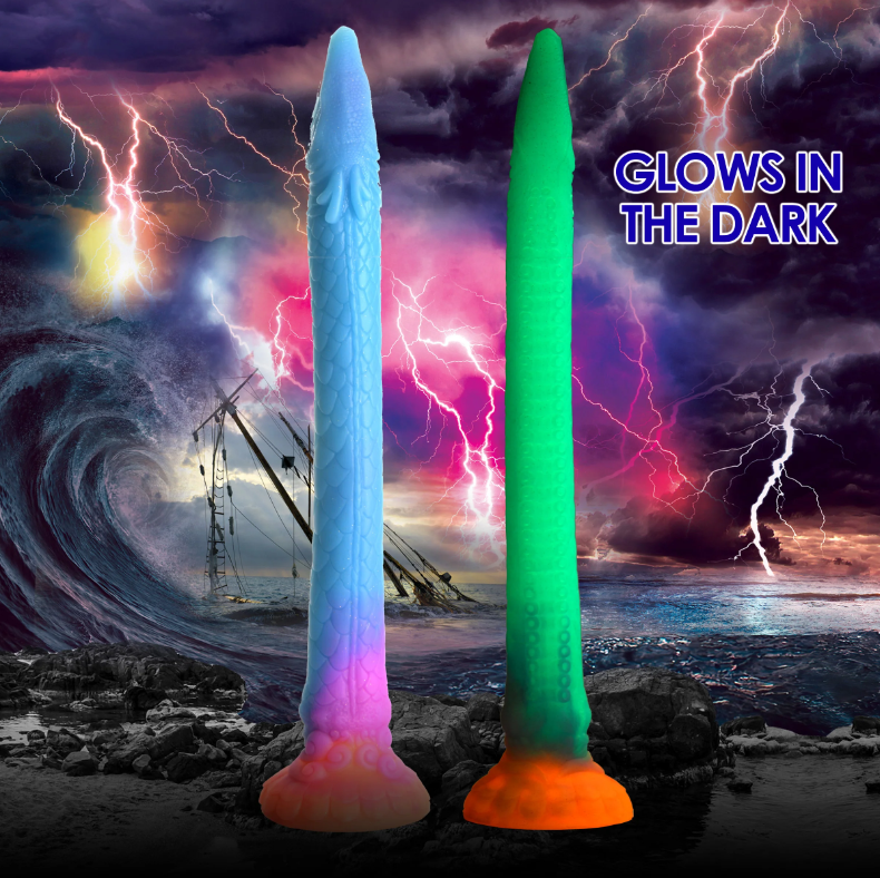 Two glow-in-the-dark silicone dildos, one blue and one green, against a stormy background.