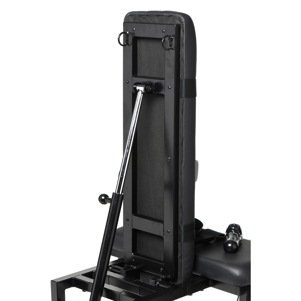 Adjustable bondage chair with a chrome support arm and a sex machine attachment.
