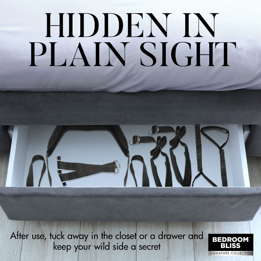 Black padded sex sling with adjustable straps in an open drawer.