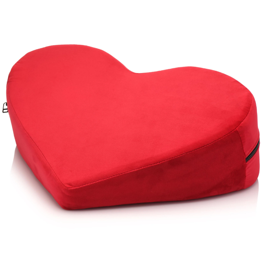 Red heart-shaped positioning pillow with a zipper.