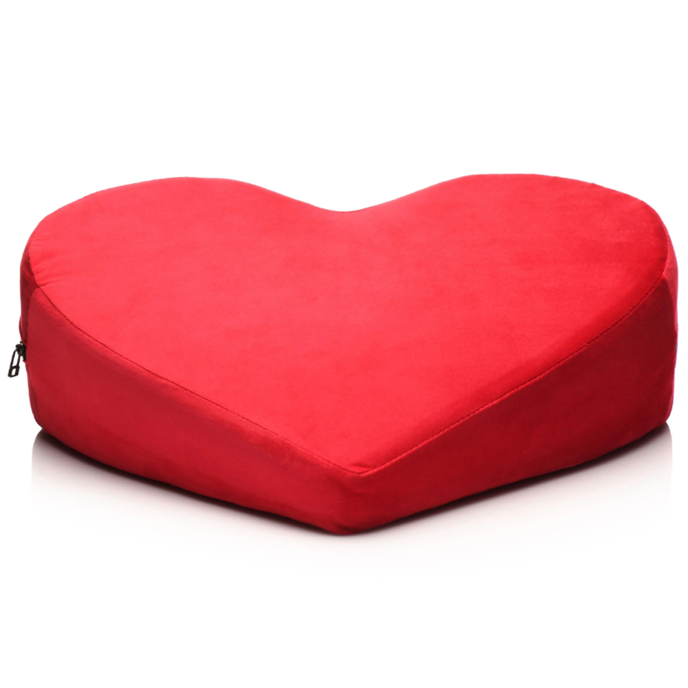 Red heart-shaped velvet positioning pillow with a zipper.