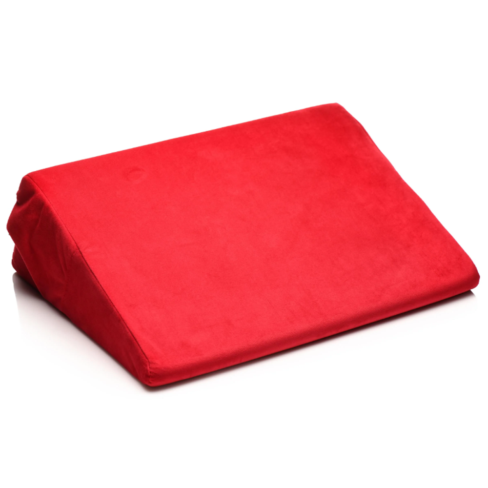Red velvet wedge pillow for support and positioning.