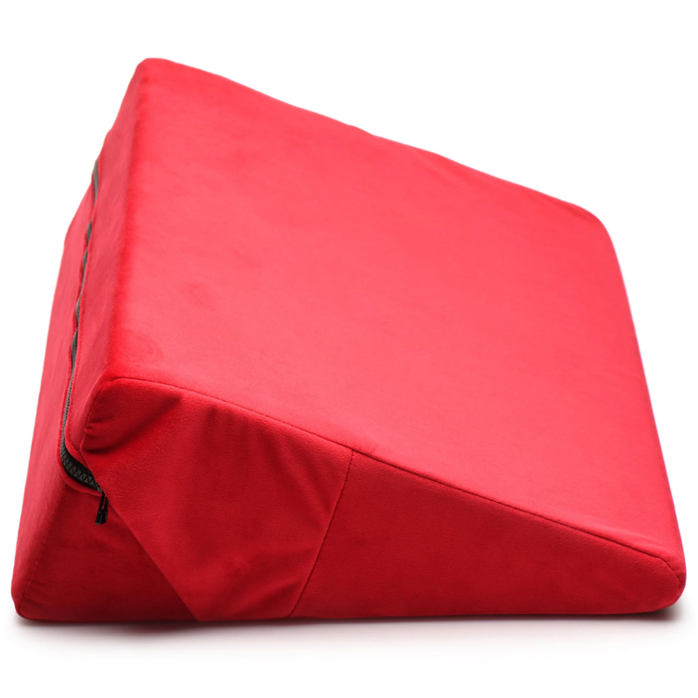 Red velvet wedge pillow with a zipper closure.