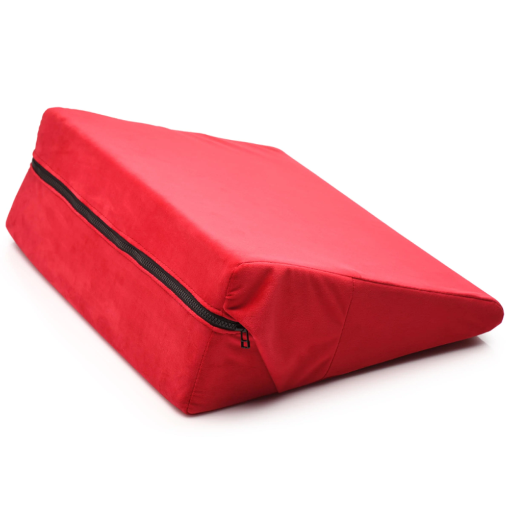 Red velvet wedge pillow with a zipper closure.