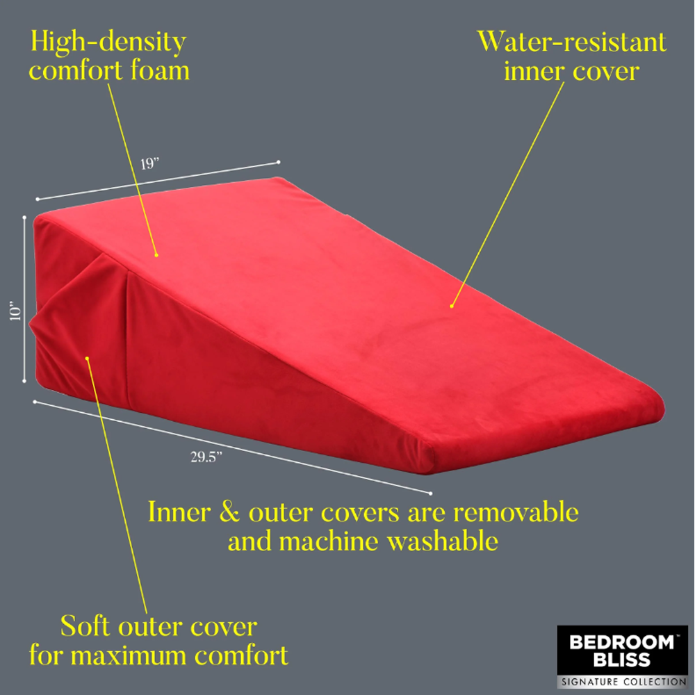 A red wedge pillow with dimensions 29.5" x 19" x 10".
