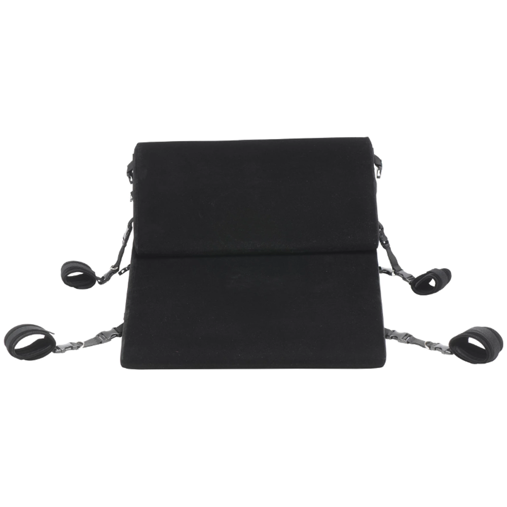 Black bondage wedge pillow with velvet cover and restraints.