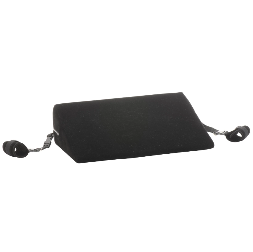 Black velvet bondage wedge pillow with restraint cuffs.