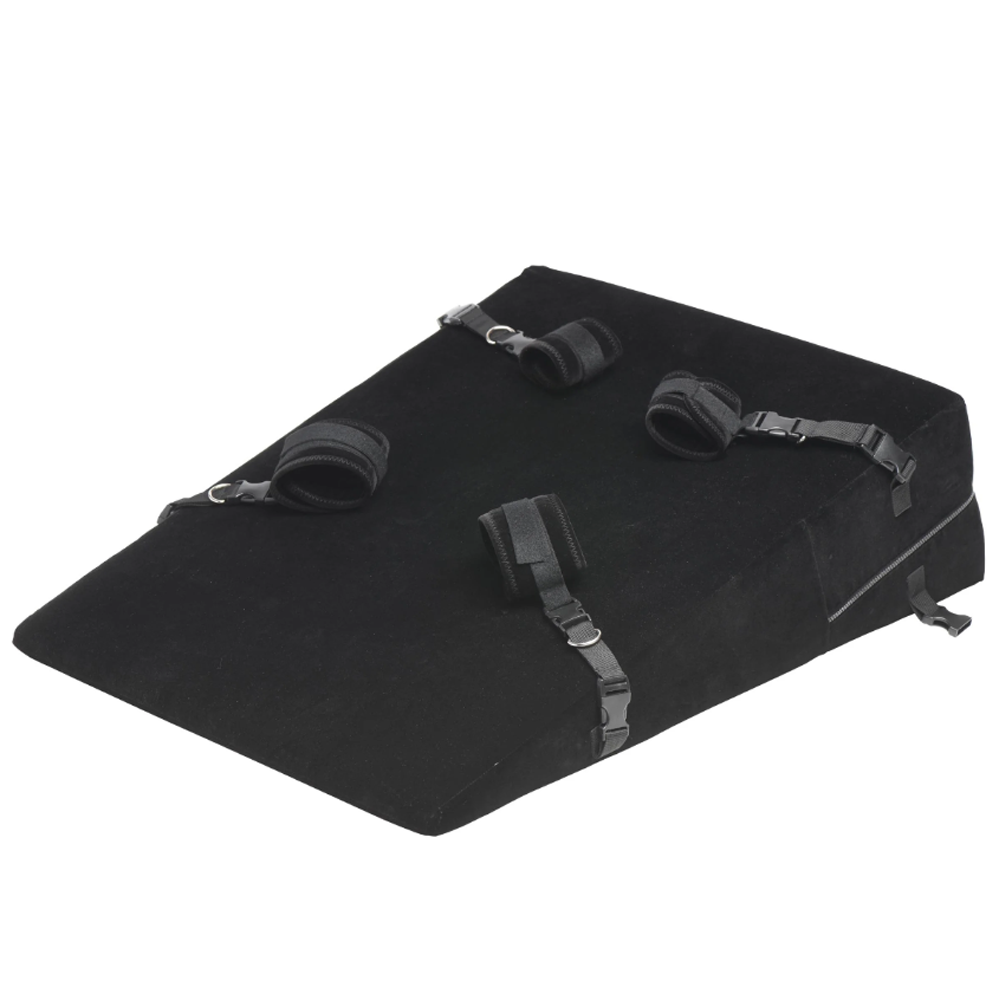 Black velvet bondage wedge pillow with four adjustable restraints.