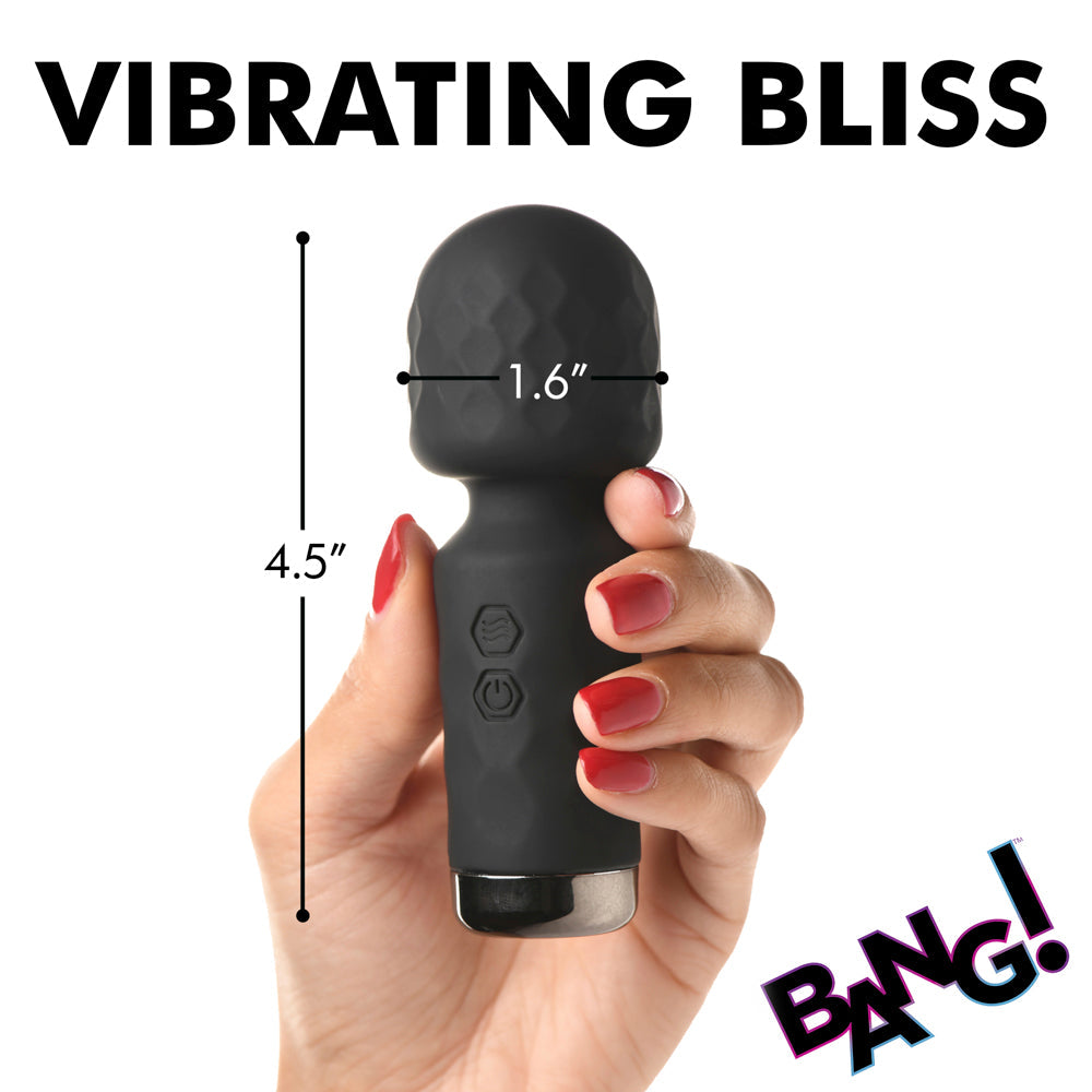 A black mini wand vibrator held in a hand, with dimensions 4.5 inches long and 1.6 inches wide.