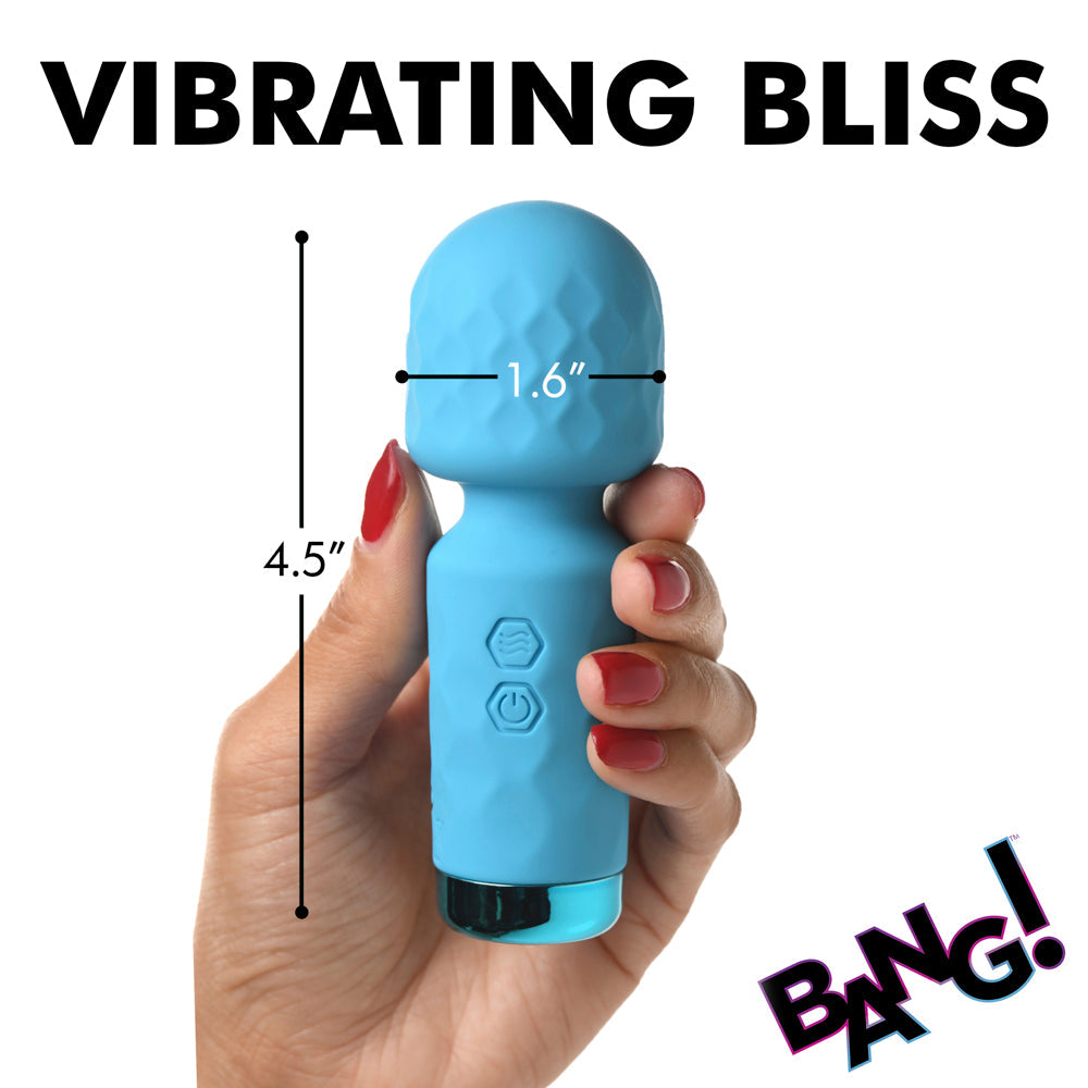 A blue silicone wand vibrator held in a hand, with dimensions indicated.