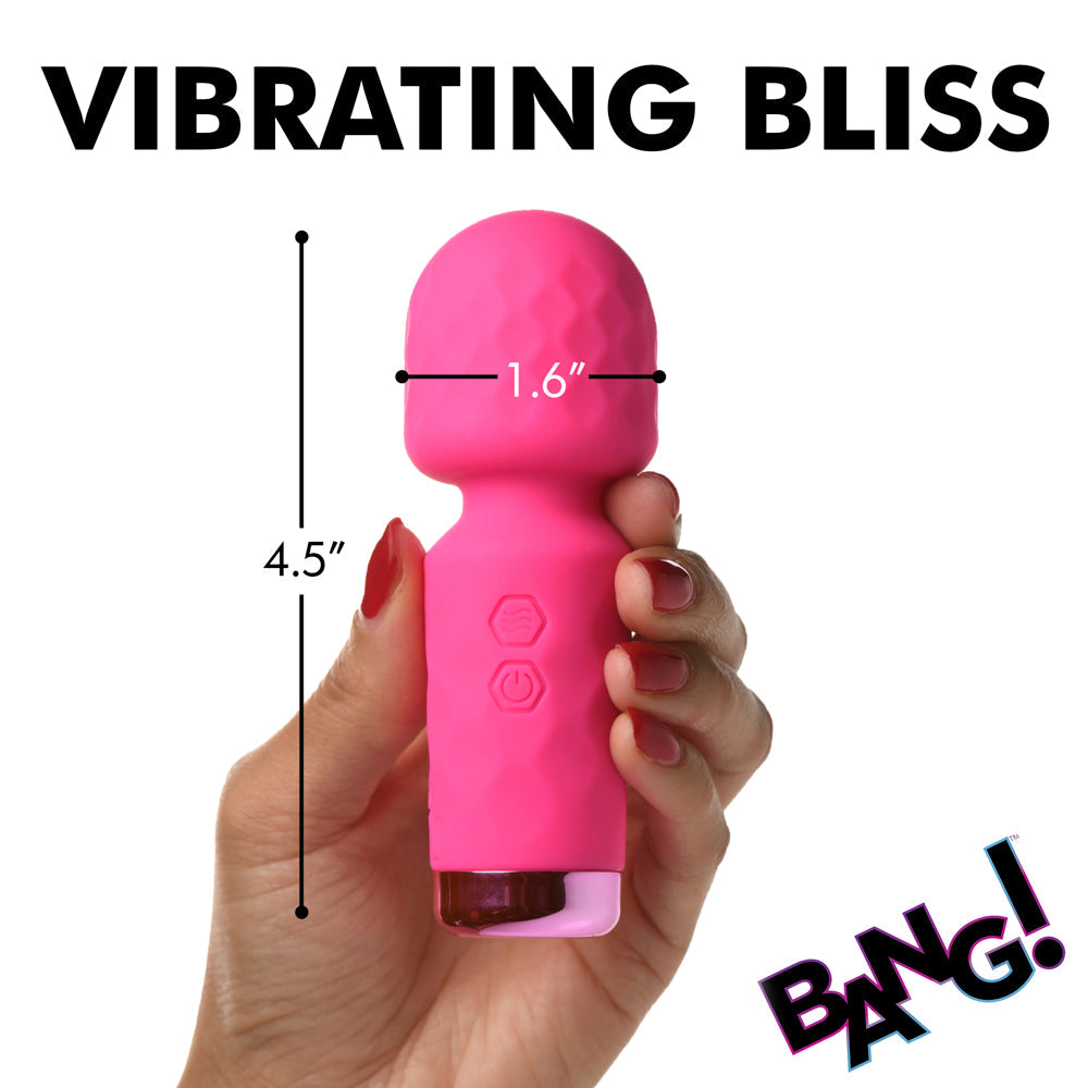 A pink mini wand vibrator held in a hand, measuring 4.5 inches long and 1.6 inches wide.