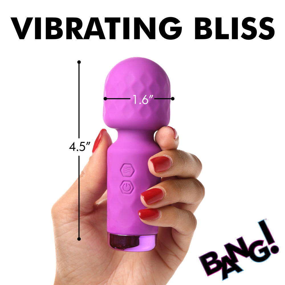 A purple mini wand vibrator held in a hand, with dimensions 4.5 inches long and 1.6 inches wide.