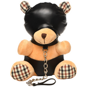 A plush teddy bear wearing a black hood and collar with a chain leash.