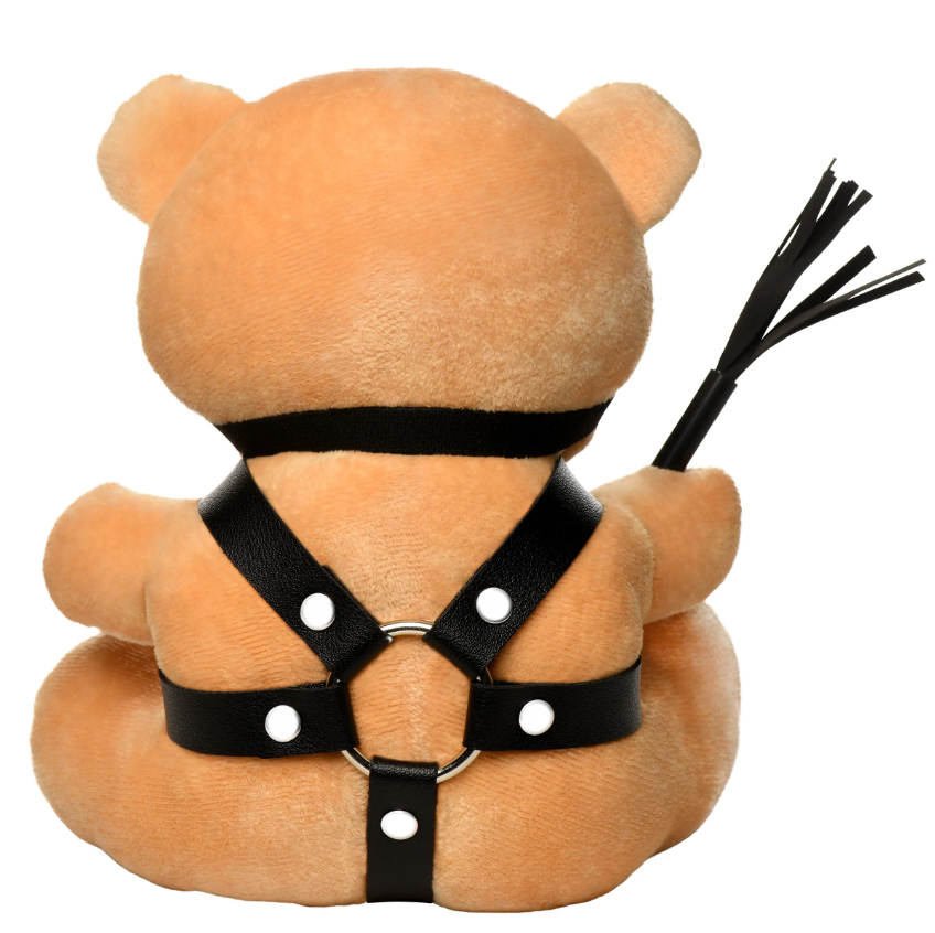 Teddy bear with faux leather harness and flogger.