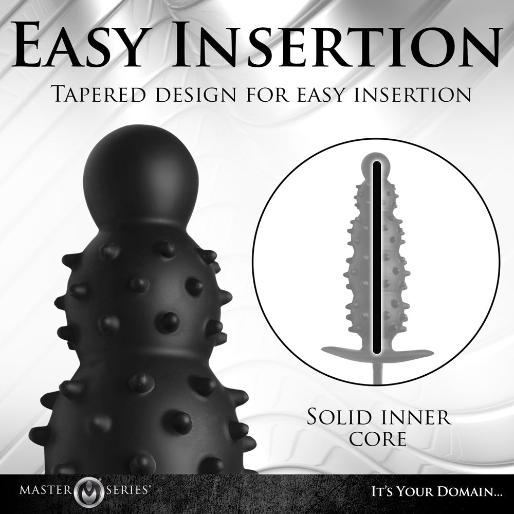 Black nubbed silicone anal plug with a tapered design and solid inner core.