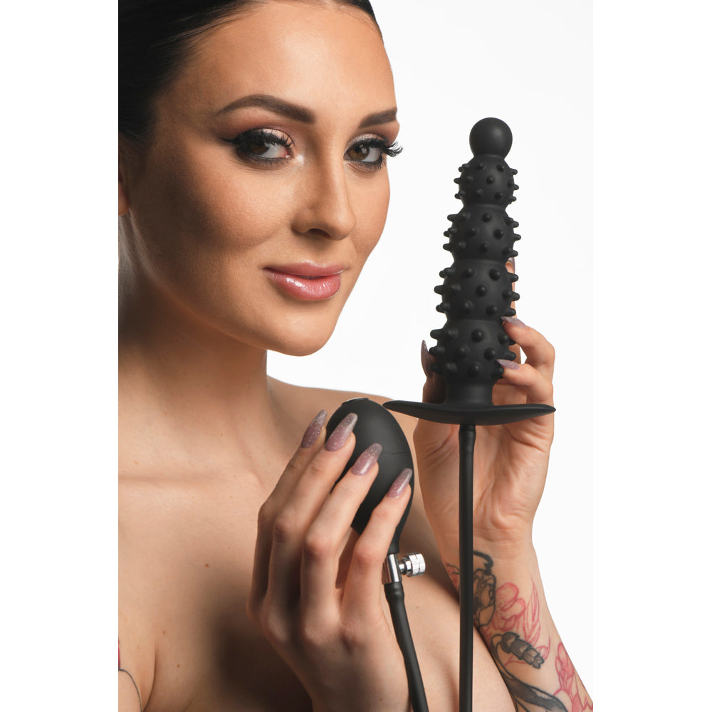 Inflatable nubbed silicone anal plug with textured bulbs and an inflation bulb.