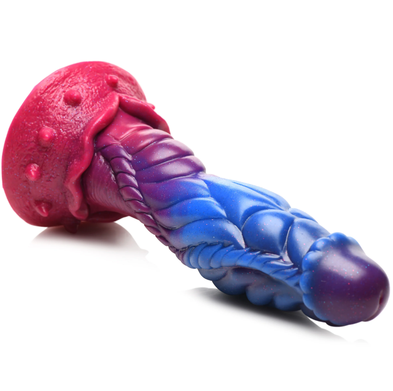 Alien-shaped silicone dildo with pink, purple, and blue gradient and glitter.
