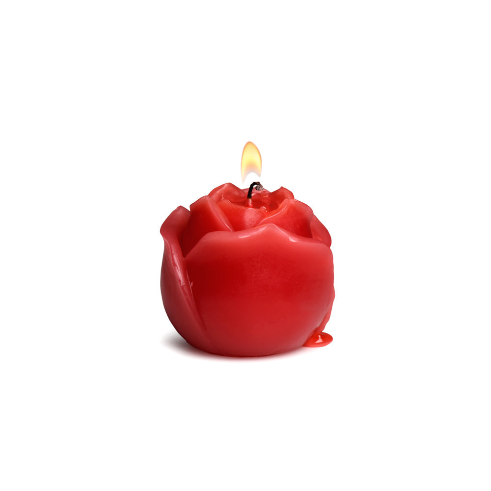 Red rose-shaped candle with a lit flame and dripping wax.