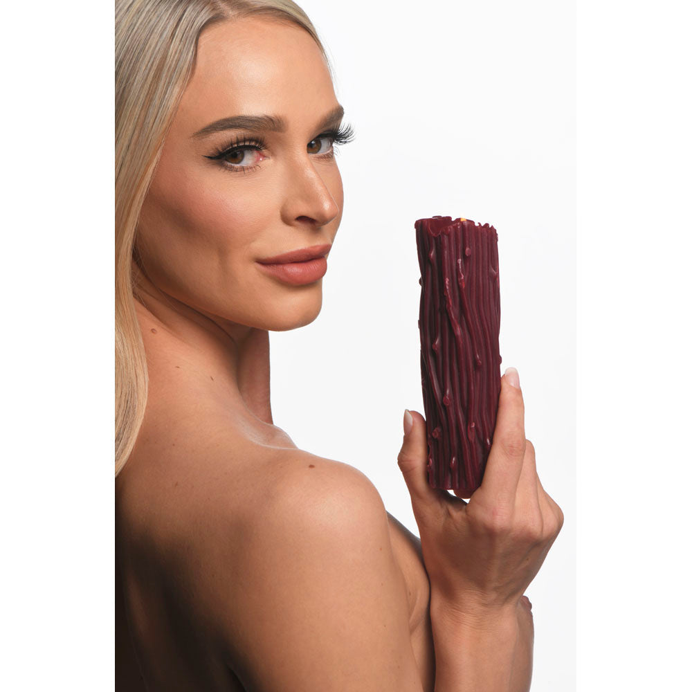 Red paraffin wax candle with a thorn pillar and drip design.