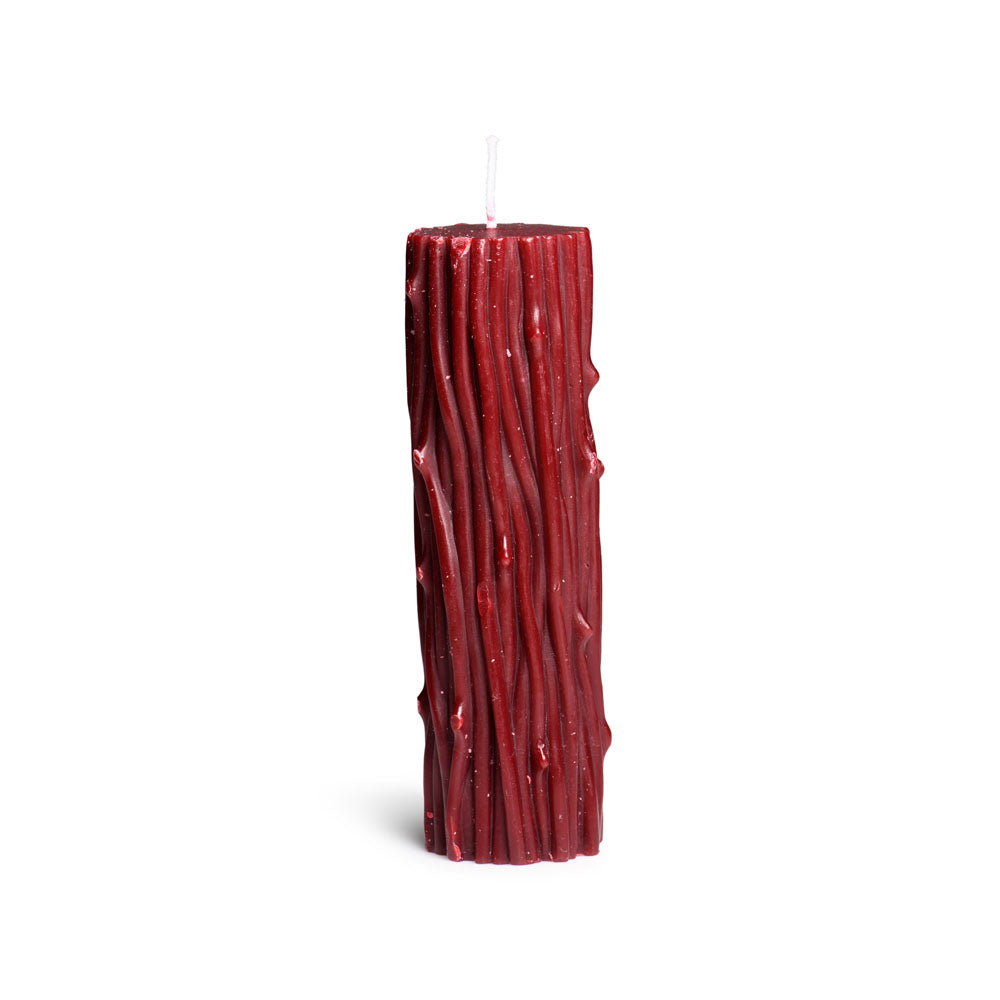 A red pillar candle with a textured, thorn-like design.