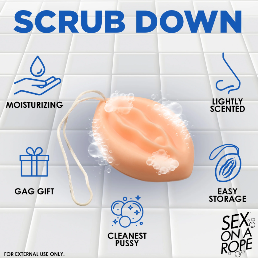A peach-colored vulva-shaped soap on a rope with text labels.
