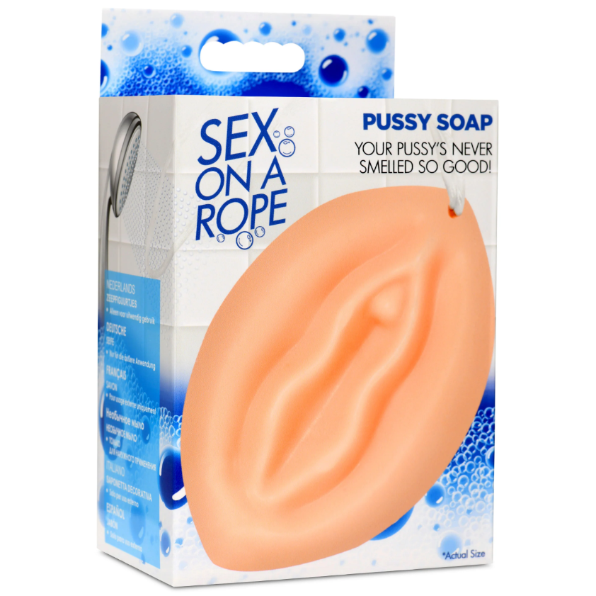 A peach-colored vulva-shaped soap with a rope for hanging.