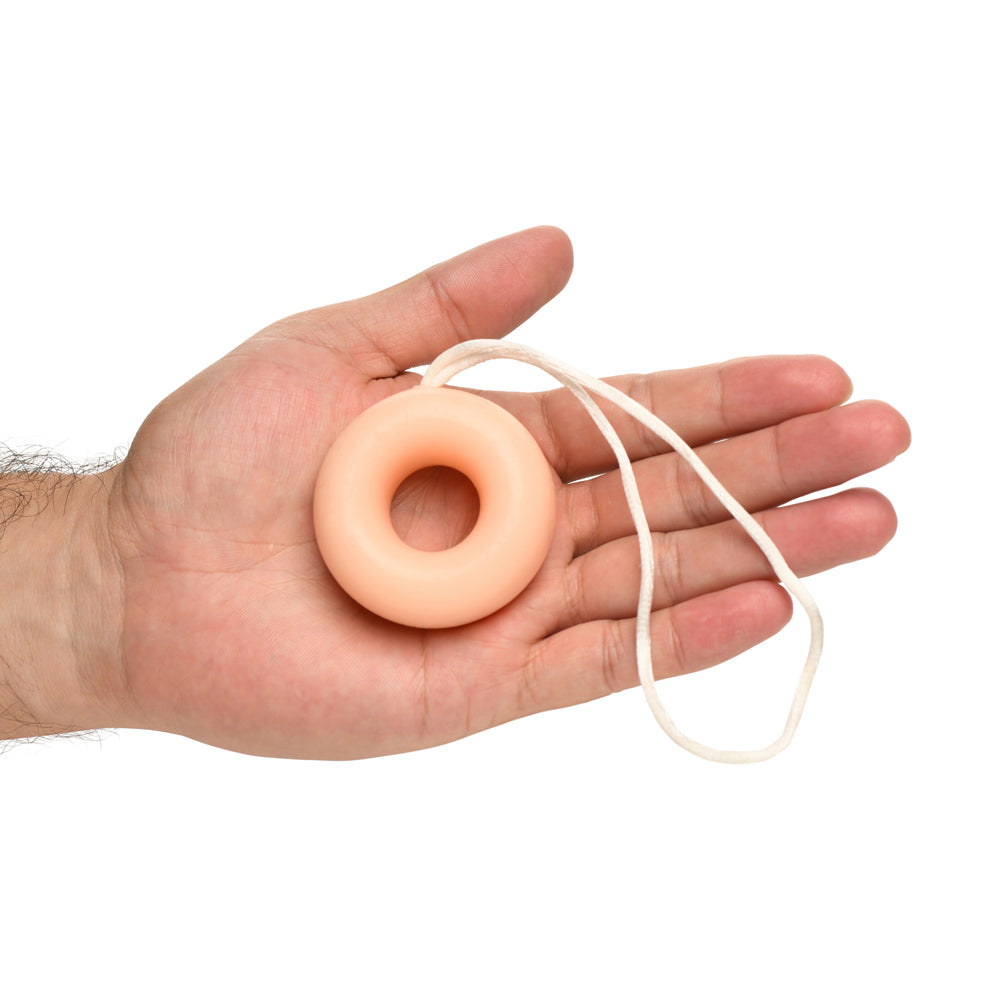 C-ring shaped novelty soap on a rope in a hand.