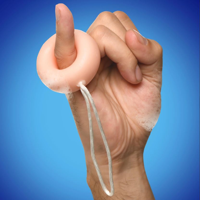C-ring shaped soap on a rope with suds.
