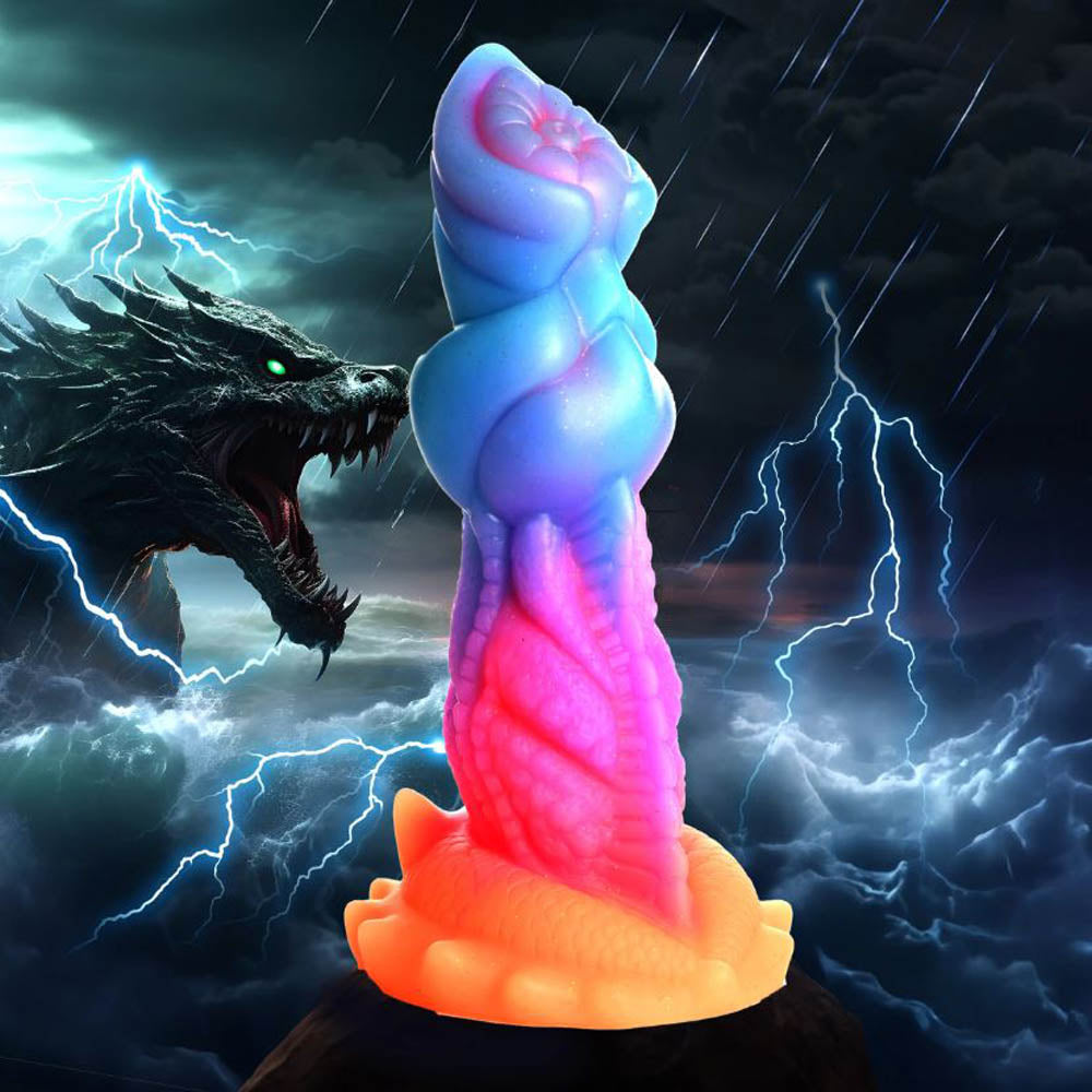 Blue and pink textured fantasy dildo with a dragon in the background.