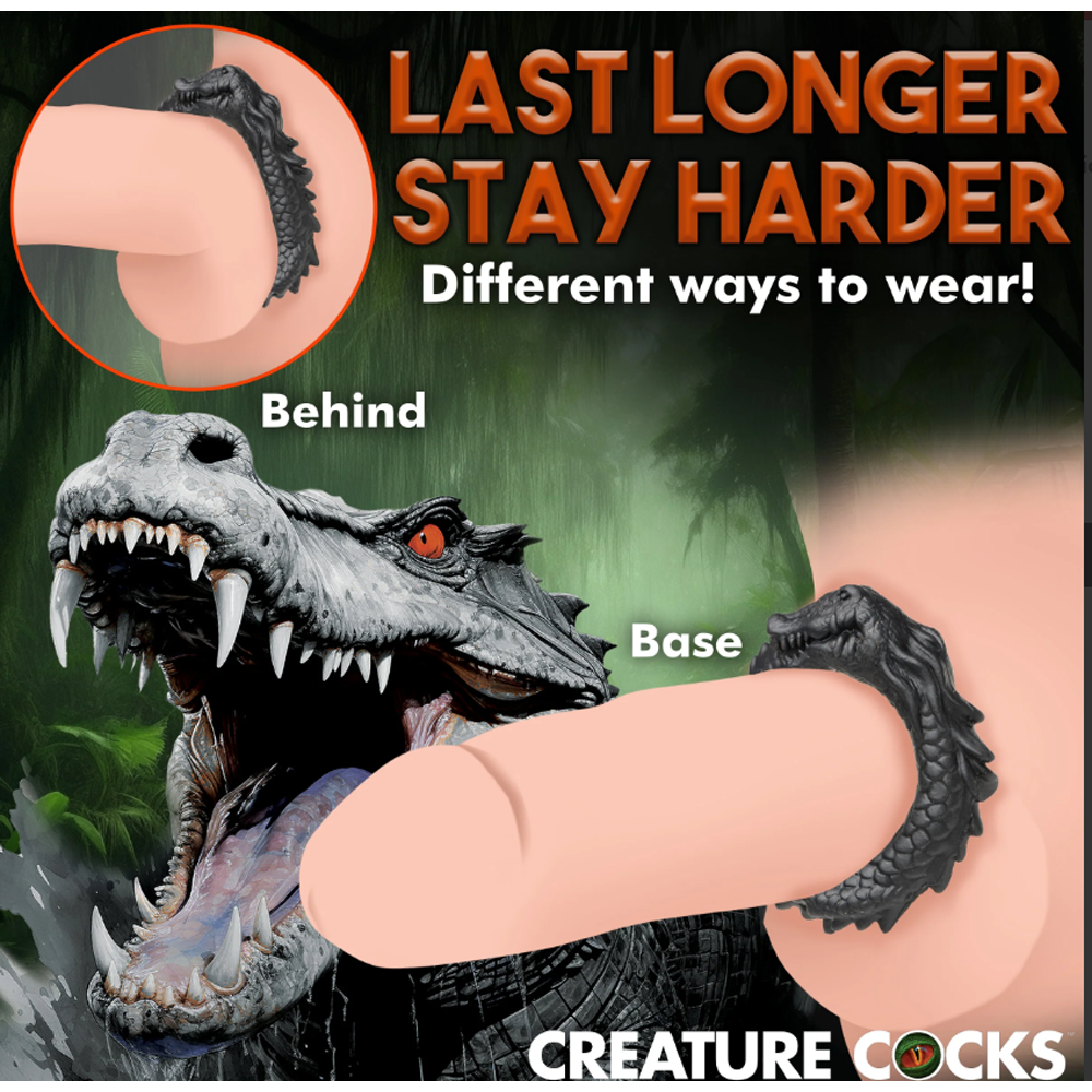 Black silicone cock ring with a caiman design, shown worn at the base and behind.