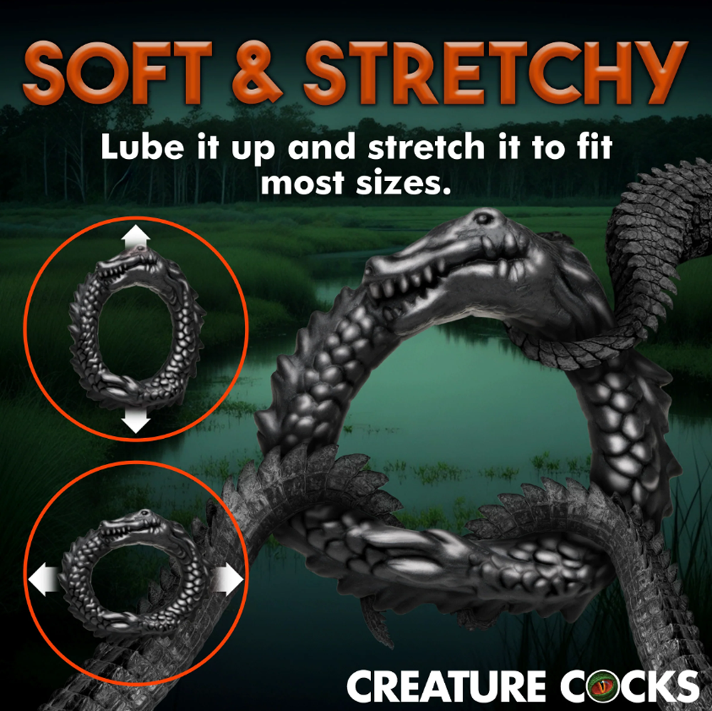 Black caiman-shaped silicone cock ring with stretching indicators.