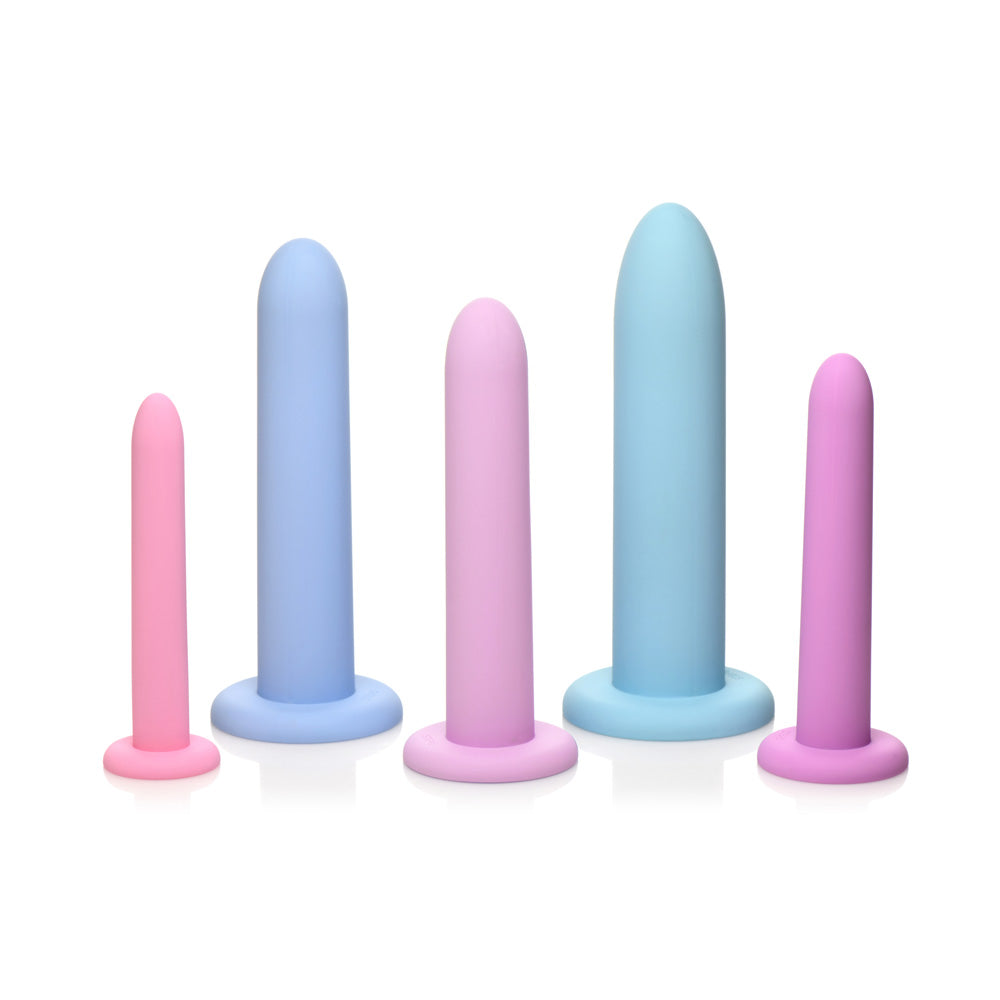 Five silicone dilators in pink and blue, in graduated sizes.