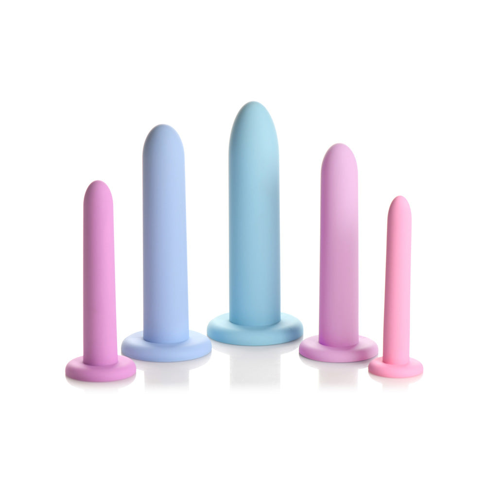 Five silicone dilators in pink, blue, and purple, arranged by size.