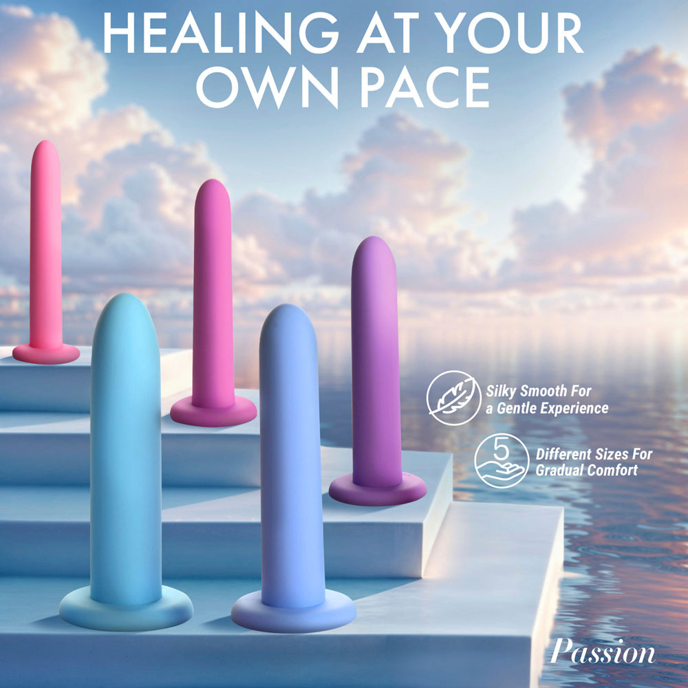 Five silicone dilators in pastel colors are displayed on white steps against a sky and water background.