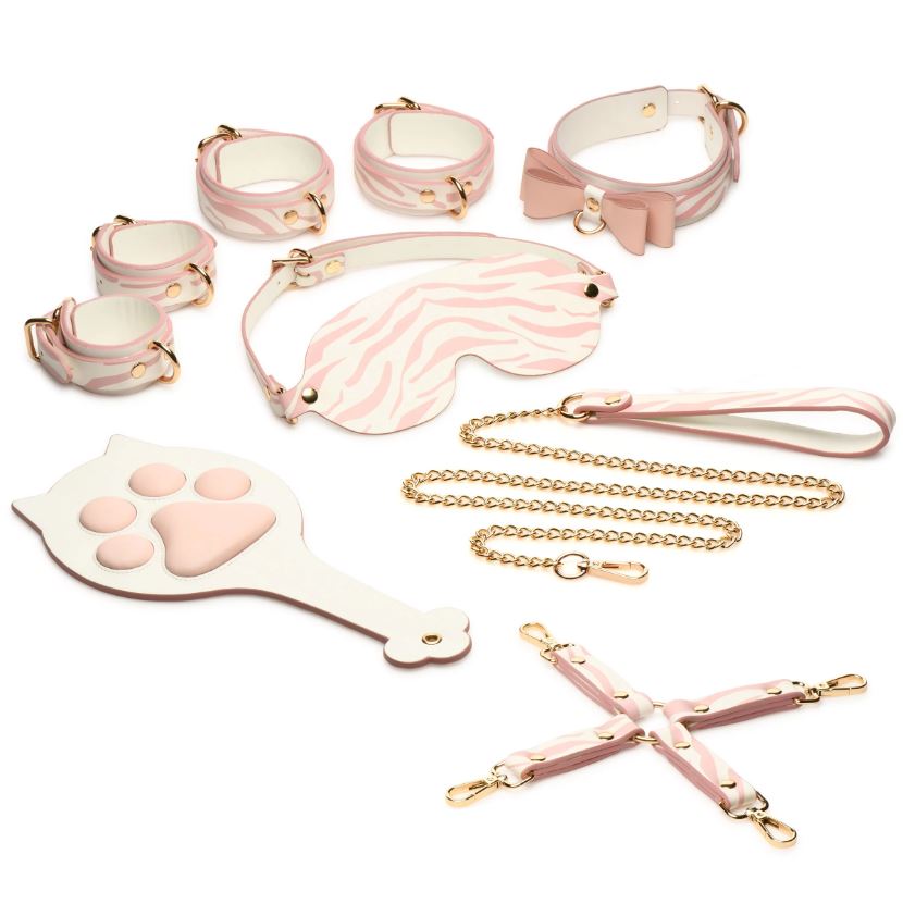 A pink and white tiger stripe bondage set with gold hardware, including cuffs, collar, leash, blindfold, hogtie, and paddle.