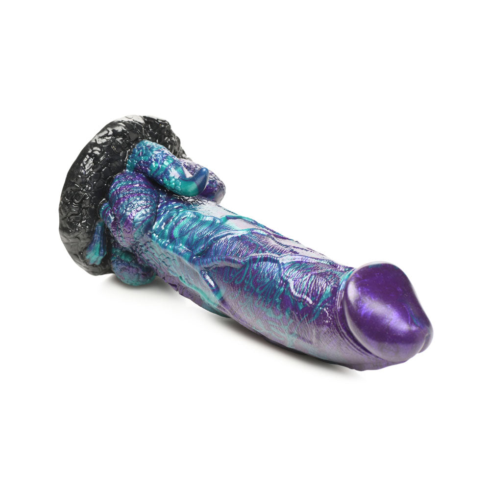 A purple and teal dinosaur-shaped silicone dildo with a black suction base.
