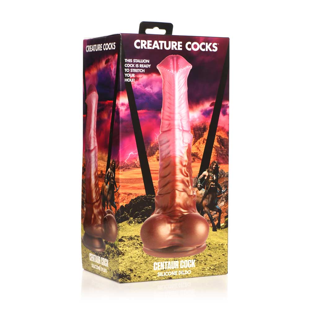 A pink silicone dildo with a textured shaft and a bulbous base, on a box with fantasy artwork.