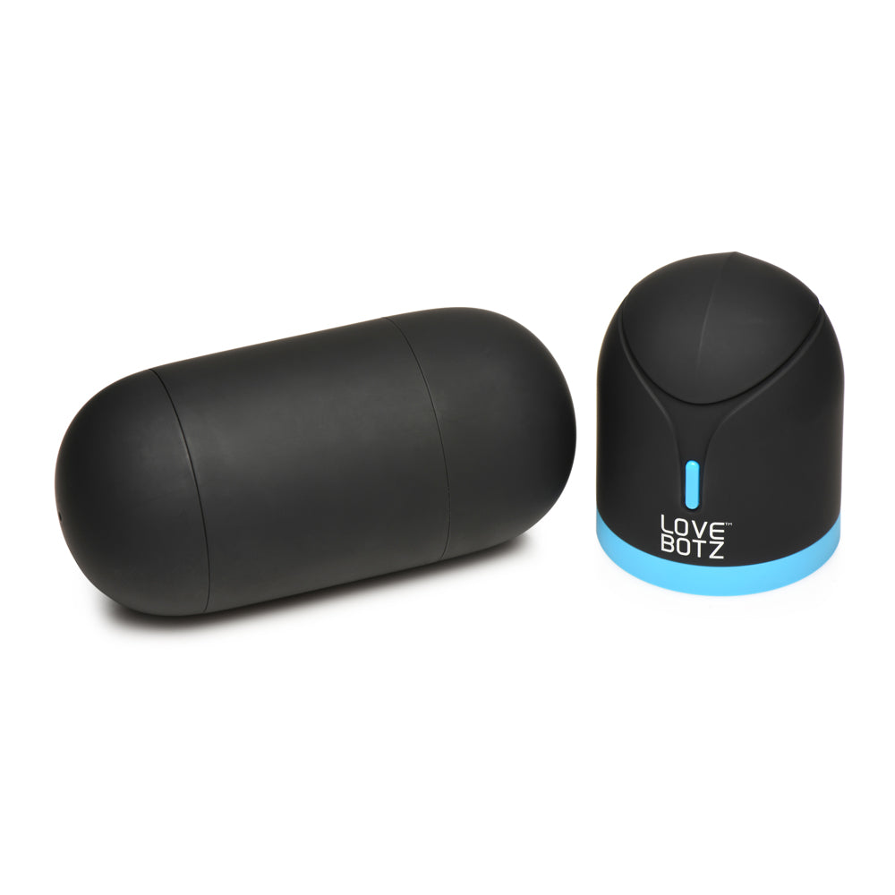 A black oval masturbator and a black and blue charging base with a light.
