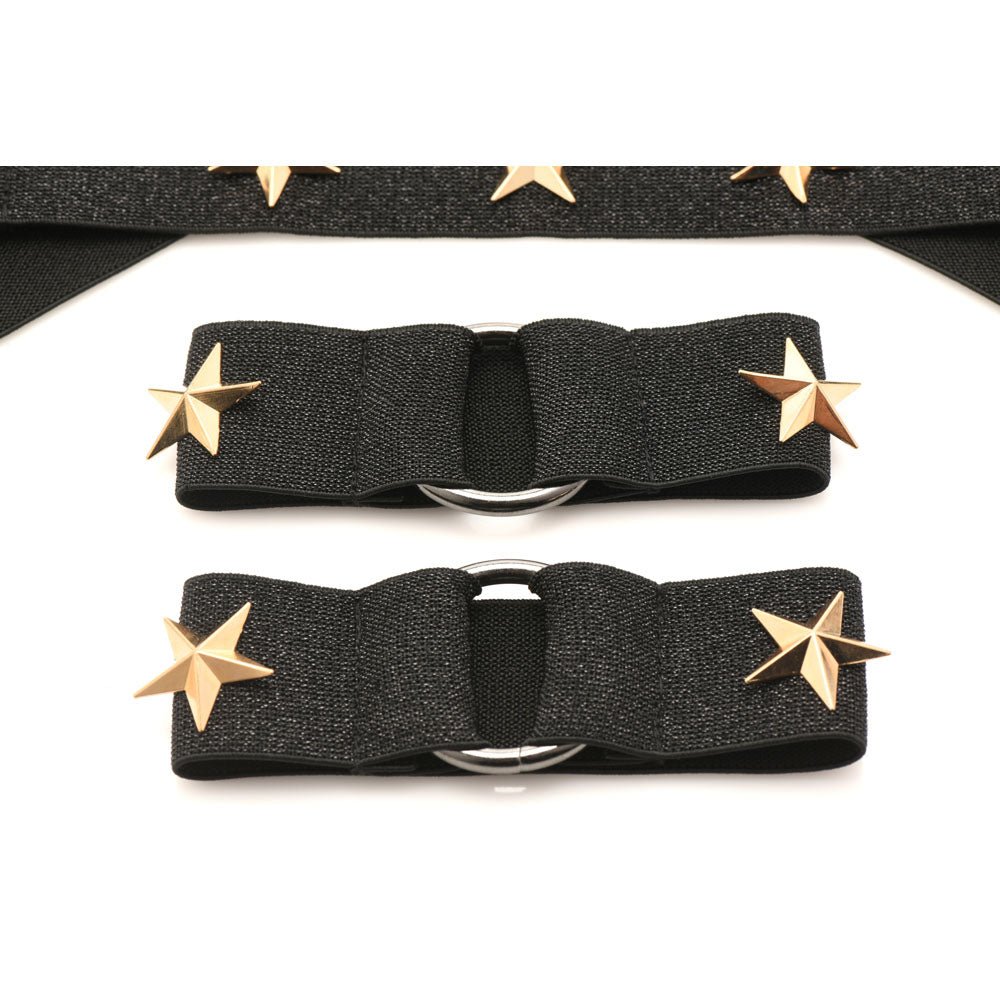 Black stretchy chest harness and arm bands with gold stars.