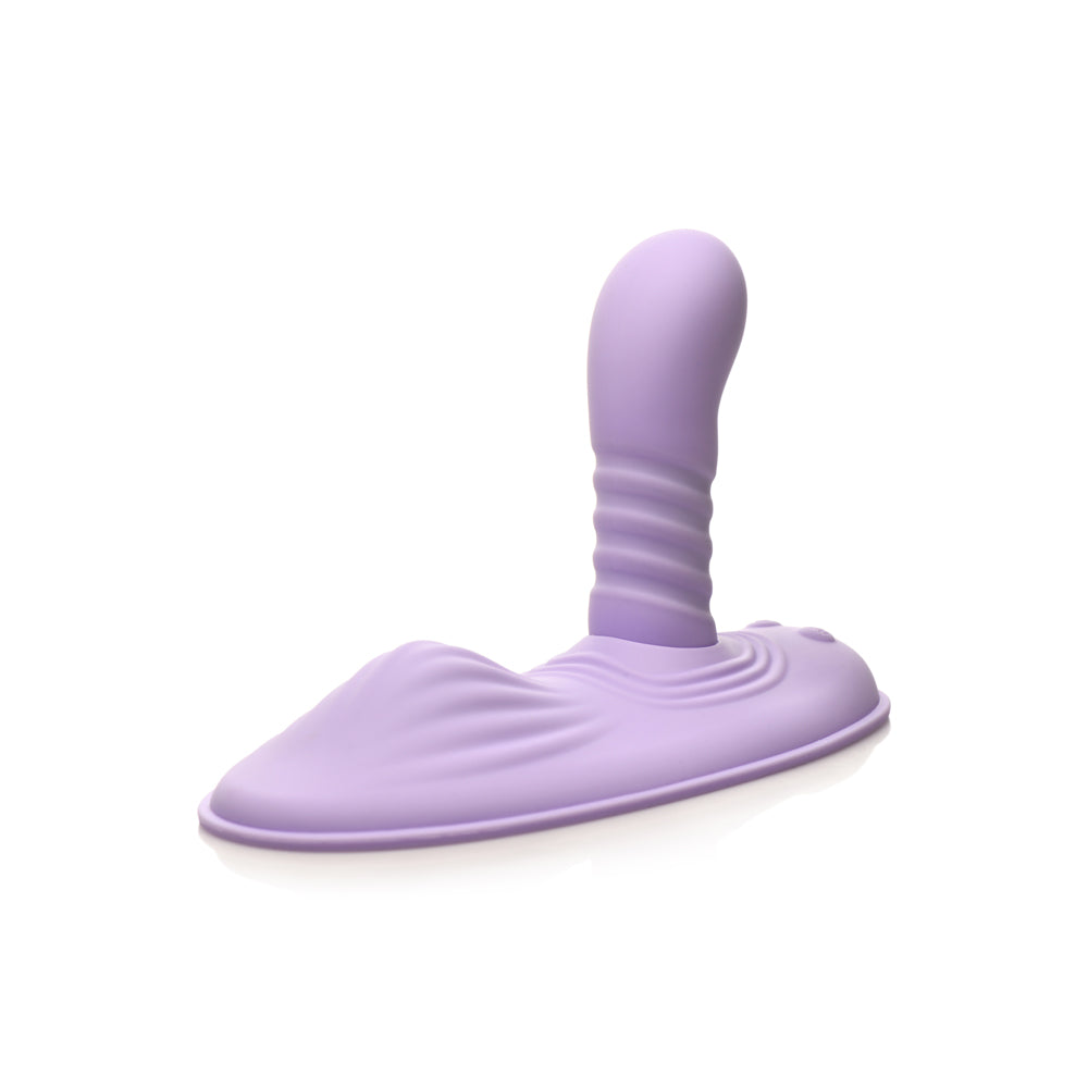 A purple silicone grinding pad with a ribbed stimulator and a textured base.