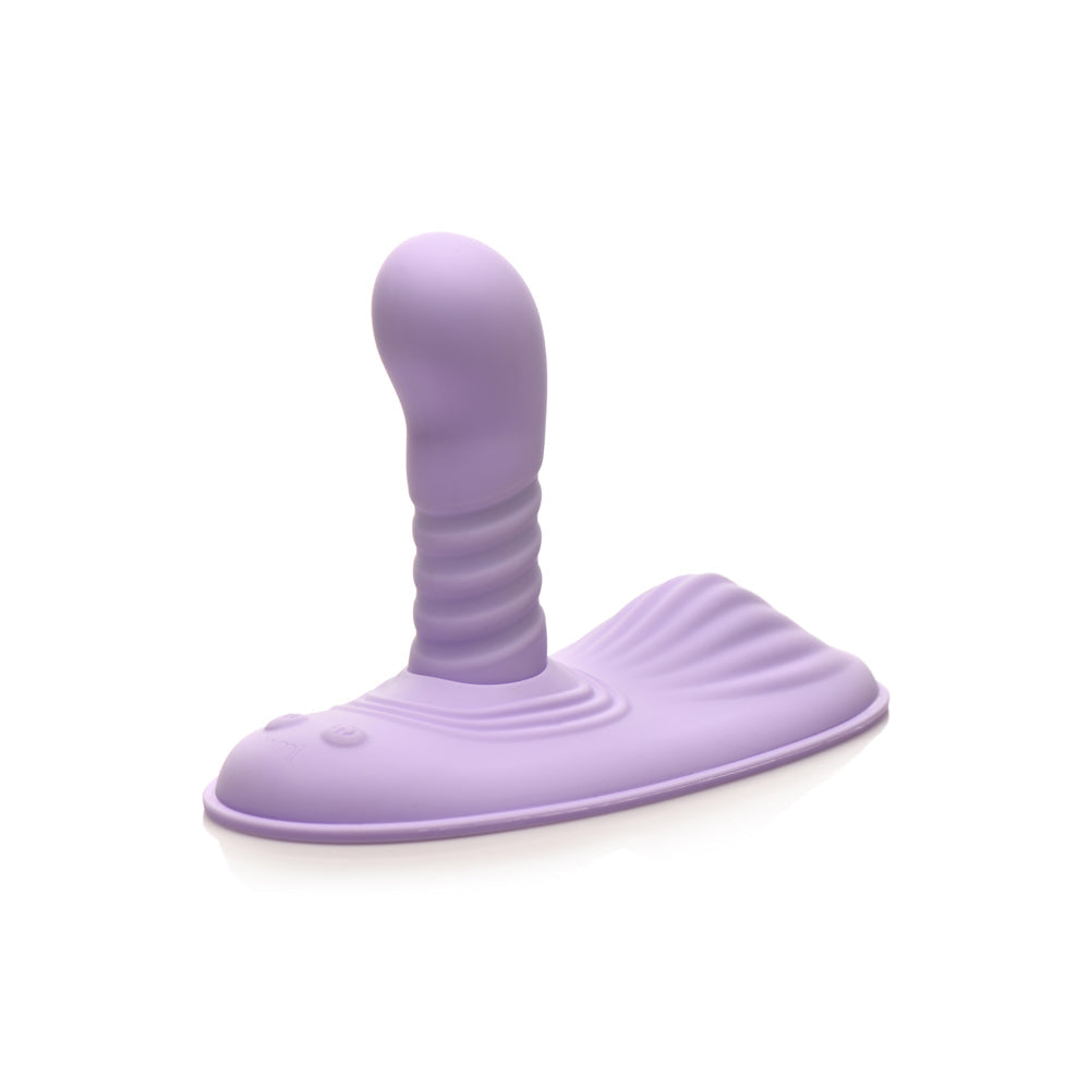 A purple silicone grinding pad with a ribbed stimulator and a textured base.