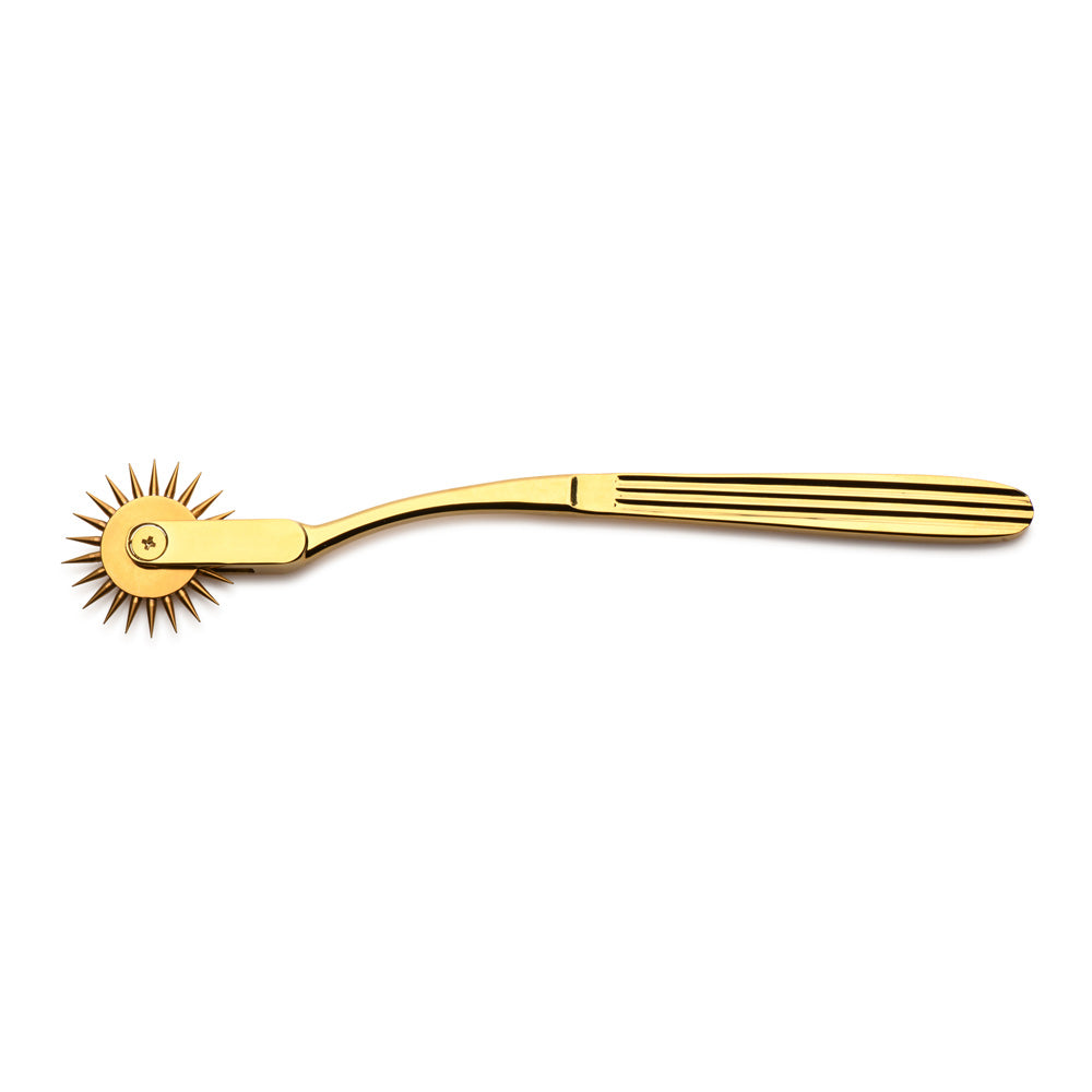 Gold stainless steel Wartenberg sensation wheel with a ridged handle.